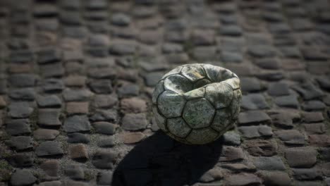 Old-soccer-ball-in-the-pavement-yard